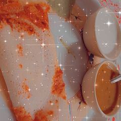 A picture of Masala Dosa with sambhar.