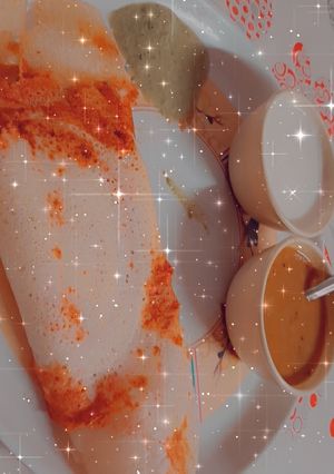 A picture of Masala Dosa with sambhar.