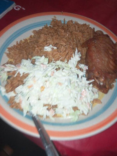 A picture of Jollof rice with salad and turkey.