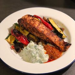 A picture of Tandoori salmon with curried roast vegetables and raita.