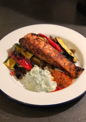 A picture of Tandoori salmon with curried roast vegetables and raita.