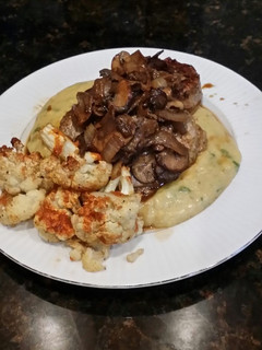 A picture of Brad's eye of round steak over jalapeño cheddar polenta.