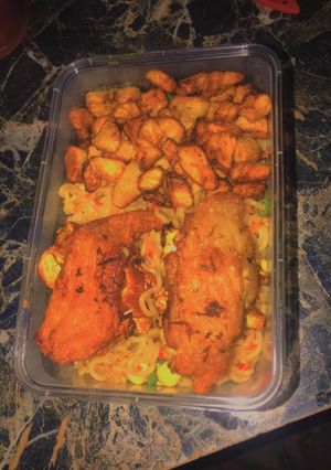 A picture of Stir fry noodles with turkey and fried plantain.