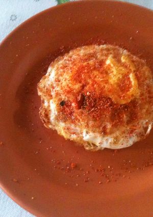 A picture of Fried egg made in an iron wok.