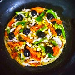 A picture of Thin Crust whole wheat Bread Pizza with pizza sauce.