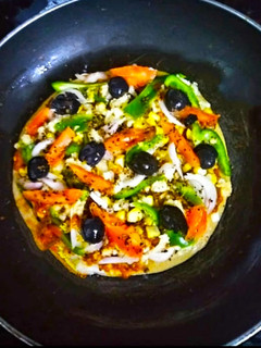 A picture of Thin Crust whole wheat Bread Pizza with pizza sauce.
