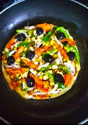 A picture of Thin Crust whole wheat Bread Pizza with pizza sauce.