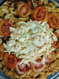 A picture of Macaroni,washed beans with salad, tomatoes and fish.