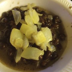 A picture of Black Beans with Vinegar-Butter, Poached Onion.