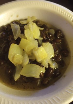 A picture of Black Beans with Vinegar-Butter, Poached Onion.