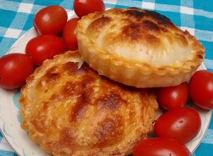 Una foto de Tarteletas de cebolla, pimiento rojo y ajo salteado, con quesos varios