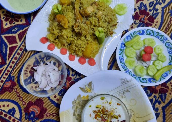 Yummy chicken pulao with salad, homemade raita,achar, and kheer