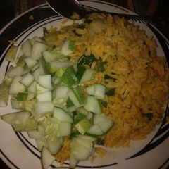 Jollof rice garnish with cucumber A picture of Jollof rice garnish with cucumber.