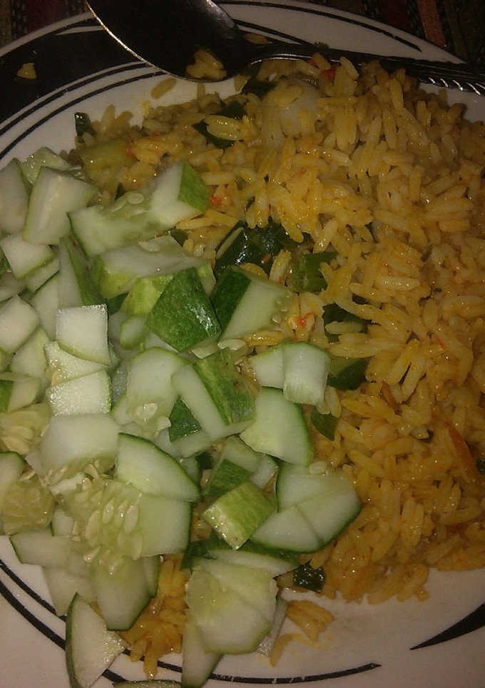 A picture of Jollof rice garnish with cucumber.