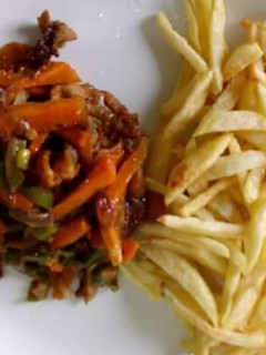 A picture of Fried yam with carrots sauce.