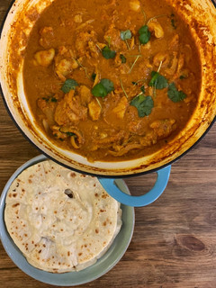 A picture of Butter chicken with instant Roti bread.