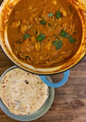 A picture of Butter chicken with instant Roti bread.