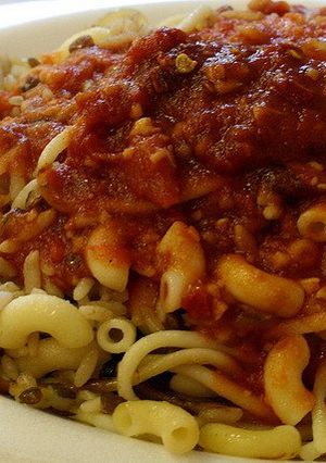 A picture of Koshari with Spicy Sauce.