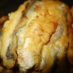 A picture of Fried fish with a beer.