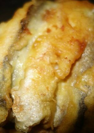 A picture of Fried fish with a beer.