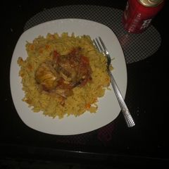 A picture of Carrot turmeric coconut rice with chicken sauce.