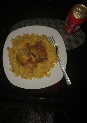 A picture of Carrot turmeric coconut rice with chicken sauce.
