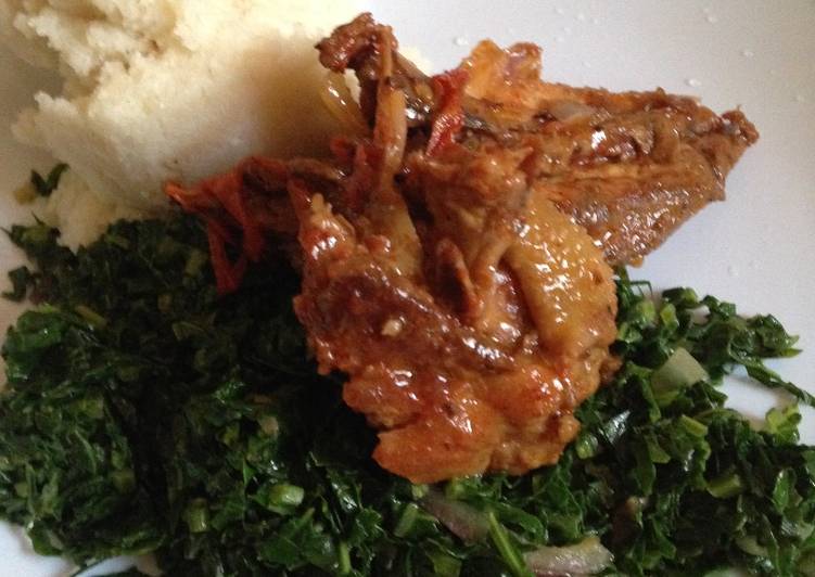 Deep fried chicken served with kale and ugali