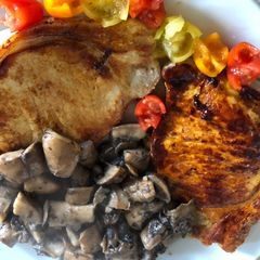 A picture of Apple-Glazed Pork Chops with Tomato “Roses”.