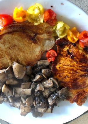 A picture of Apple-Glazed Pork Chops with Tomato “Roses”.
