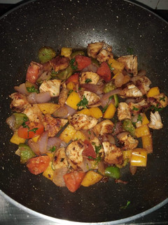 A picture of Sauteed chicken with veggies.