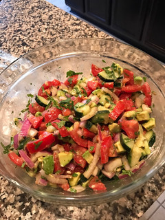 A picture of Tomato, cucumber, avocado salad.