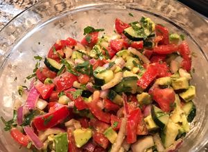 A picture of Tomato, cucumber, avocado salad.