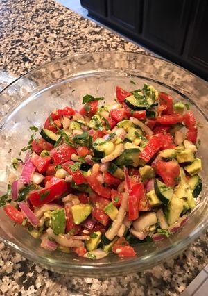 A picture of Tomato, cucumber, avocado salad.