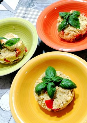 A picture of Fresh Couscous with Pesto, Tomatoes, Cheese, and Eggs.