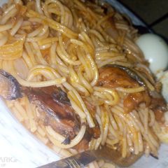 Spaghetti jollof with dried fish and boiled eggs A picture of Spaghetti jollof with dried fish and boiled eggs.