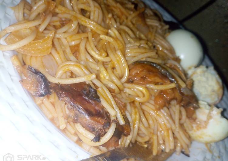 Spaghetti jollof with dried fish and boiled eggs