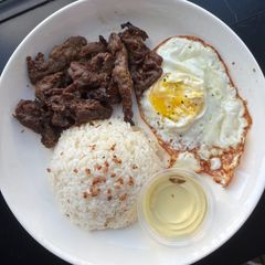 A picture of Garlic rice with lemongrass pork and fried egg.