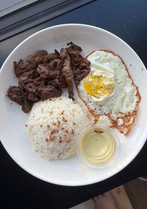 A picture of Garlic rice with lemongrass pork and fried egg.
