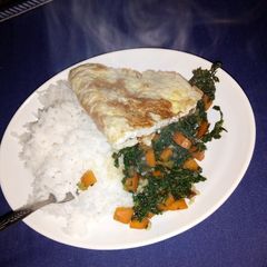 A picture of Rice kales and pan fried eggs.