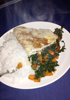 A picture of Rice kales and pan fried eggs.