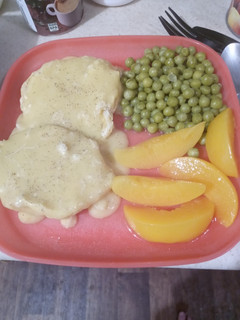 A picture of Creamy Chicken Over Buttered Biscuits with Sweet Peas.