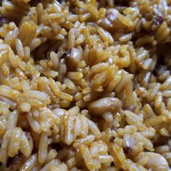 A picture of Simple Palm oil jollof rice and beans with locust beans.