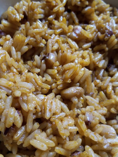 A picture of Simple Palm oil jollof rice and beans with locust beans.