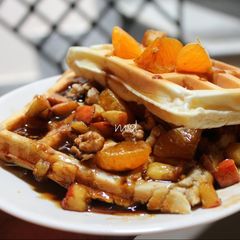 A picture of Waffle with walnuts apple and honey.
