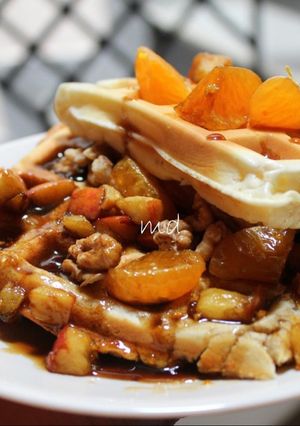 A picture of Waffle with walnuts apple and honey.