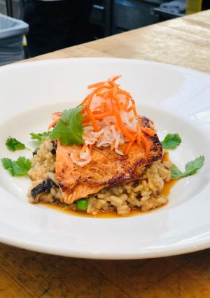 A picture of Bahn-Mi Glazed Salmon with Pho Broth Risotto.