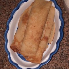 Plantain pancake filled with scotch egg A picture of Plantain pancake filled with scotch egg.