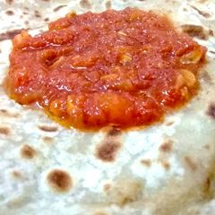 A picture of Aalu Ka Paratha with Tamater ki chatni.
