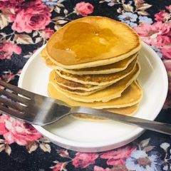 A picture of Dollar pancakes with dash of honey.