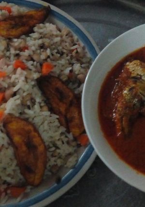 A picture of Rice,beans, plantain and fish stew.